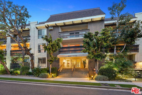 Front view of a multi-story residential building with balconies.