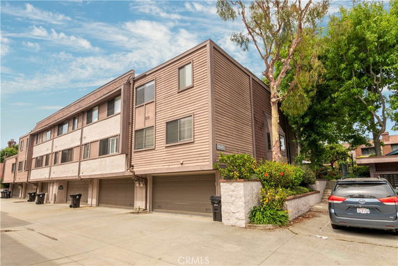 Front view of a multi-story residential building with garage parking.