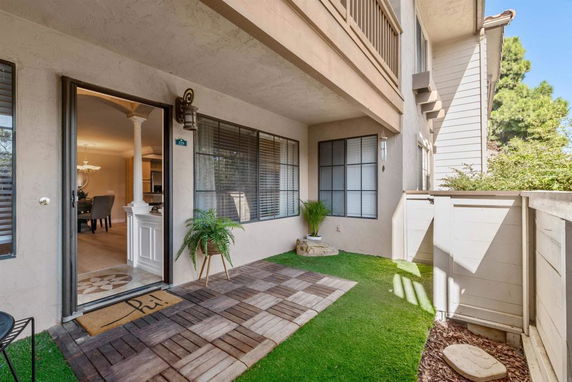 Front view of a house with a small outdoor patio area.