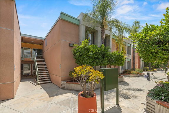 Front view of a two-story building with an exterior staircase.