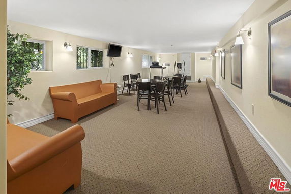 Interior view of a clubhouse with seating and tables.