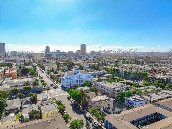 Wide-angle view of a city with various buildings and industrial structures visible in the distance.