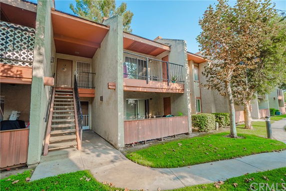 Front view of a multi-story apartment building with balconies.
