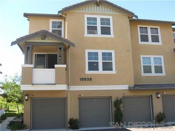Front view of a multi-story house with multiple garage doors.