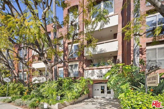 Front view of a multi-story condominium building with balconies.