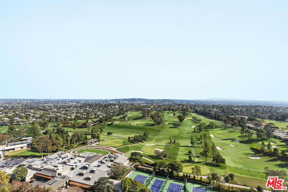 Wide-angle view of a golf course and surrounding area.