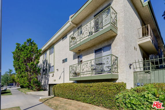 Front view of a multi-story building with balconies.