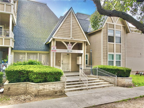 Front view of a building with a steep roof and entryway