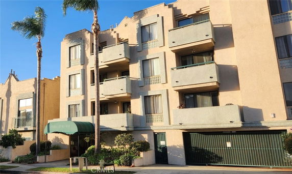 Front view of a multi-story building with balconies.