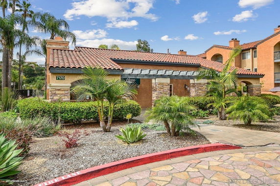 Front view of a building with a tiled roof and stone accents.