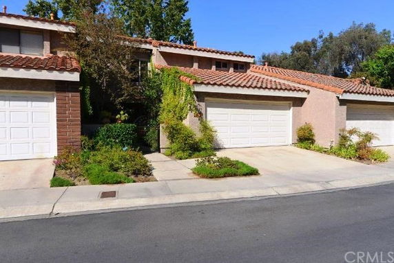 Front view of a house with a double garage and tiled roof.