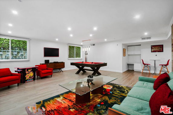 Room with pool table, seating area, and entertainment features