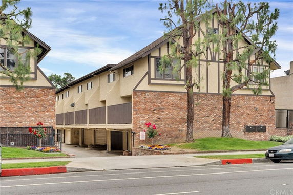 Front view of a multi-story building with brick and stucco exterior.