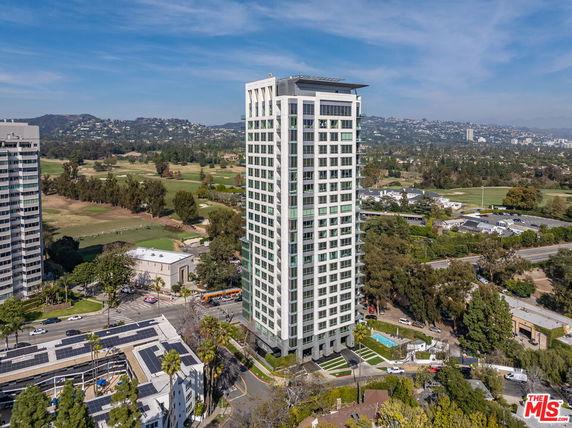 Front view of a tall, modern high-rise building.