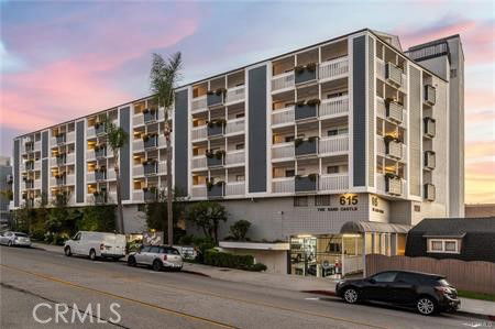 Front view of a multi-story residential building with balconies.