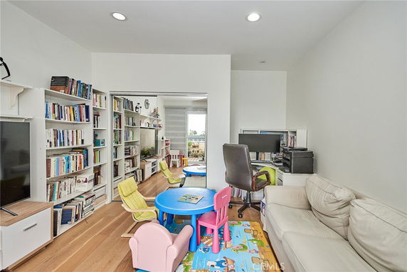 Room with bookshelves, children's play table, and seating area