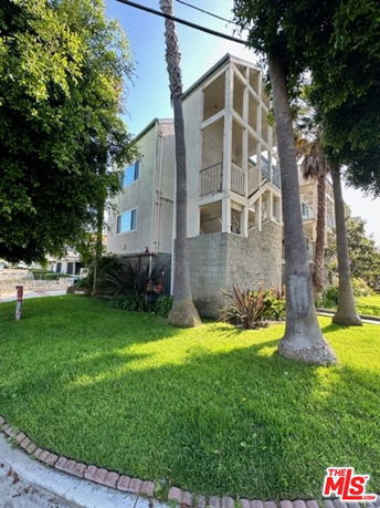 Front view of a multi-story building with balconies.