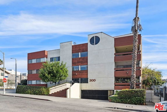 Front view of a multi-story residential building with modern design.