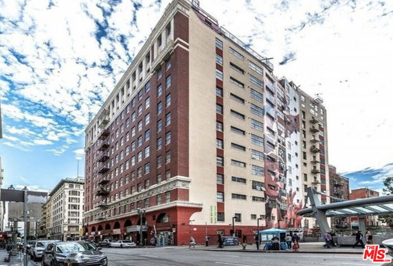 Front view of a multi-story building with brick and light-colored facade.