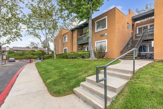 Front view of a multi-story apartment building with exterior staircases.