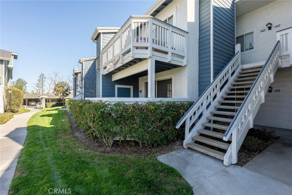 Front view of a residential building with a staircase leading to the upper level.