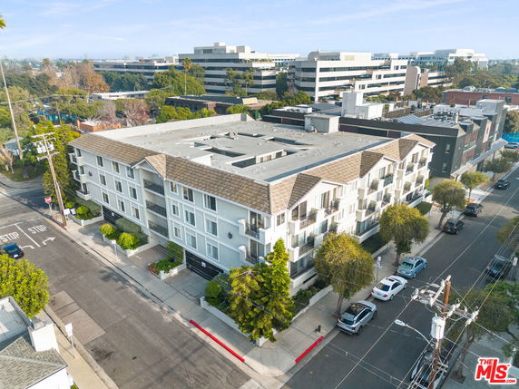 Aerial view of a multi-story residential building with a pitched roof.