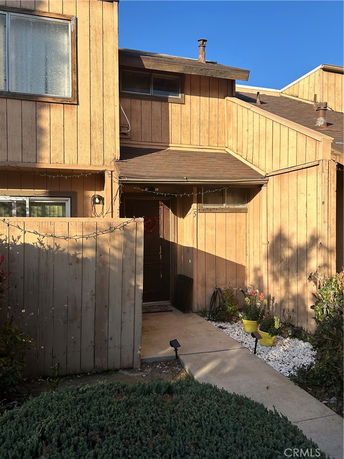 Front view of a two-story house with wood siding and a main entrance.