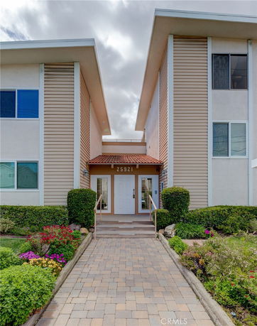 Front view of a building with dual entrances and a pitched roof.