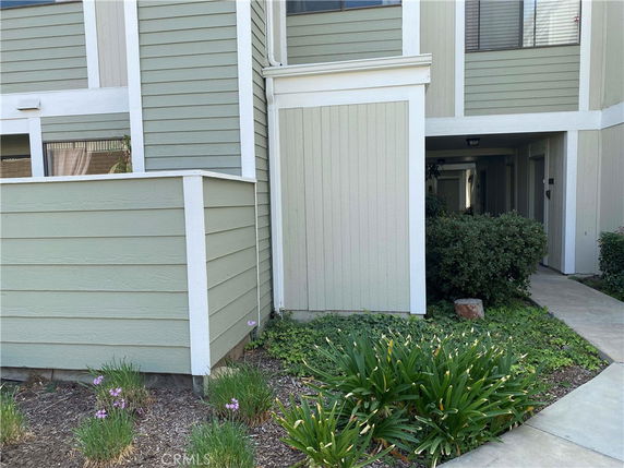 Front view of a building with green siding and white trim.
