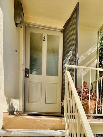 Front door of a building with a small staircase and railing.