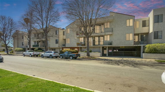 Front view of a multi-story residential building with balconies.