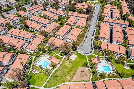 Aerial view of a residential community with multiple buildings, swimming pools, and green spaces.