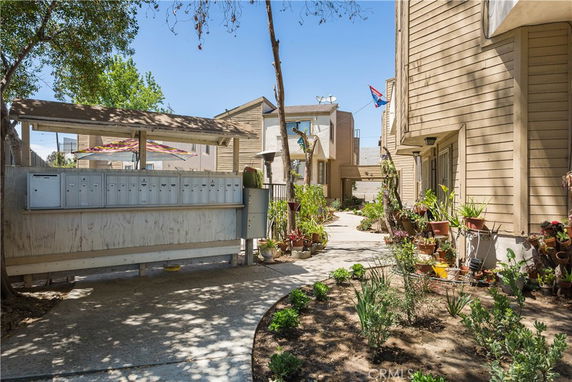 Front view of a residential building with multiple units and mailbox area.