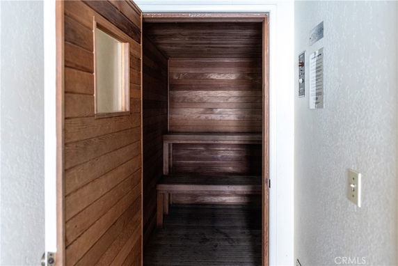 Wood-paneled sauna room with seating