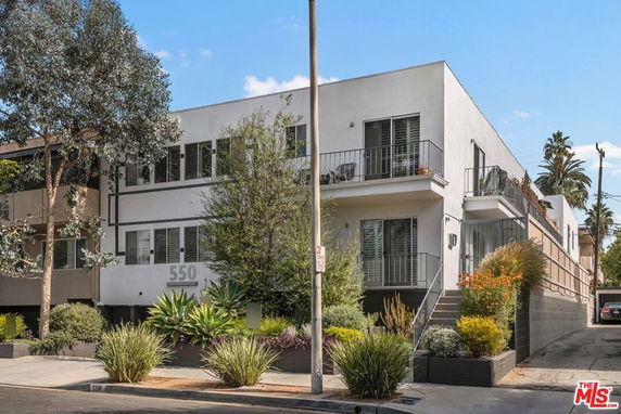 Front view of a modern two-story apartment building with balconies.