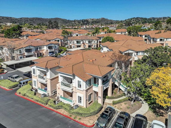 Aerial view of a residential area with multiple two-story houses featuring red-tiled roofs.