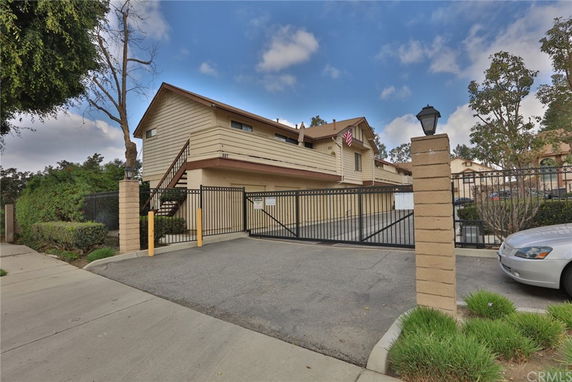 Front view of a two-story house with a gated driveway.