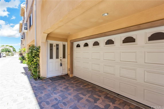 Front view of a house with a garage and entrance door.