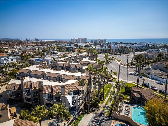 Panoramic view of a residential area with multiple houses and nearby beach.