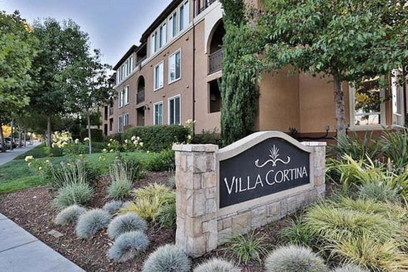 Front view of a multi-story residential building with a sign reading 'Villa Cortina'.
