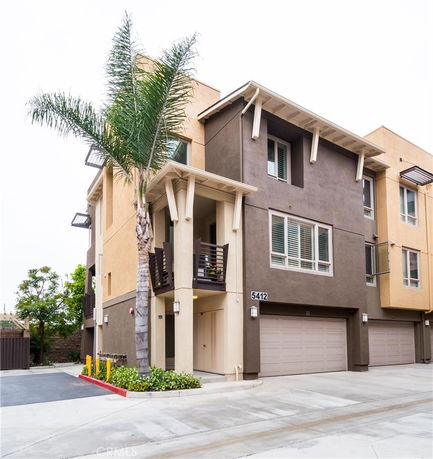 Front view of a modern multi-story townhouse with a garage.