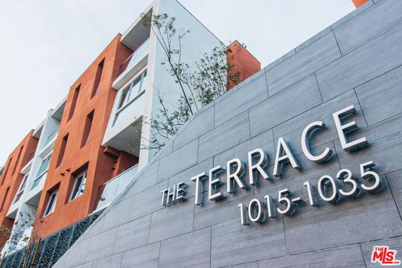 Front view of a modern multi-story building with prominent signage.