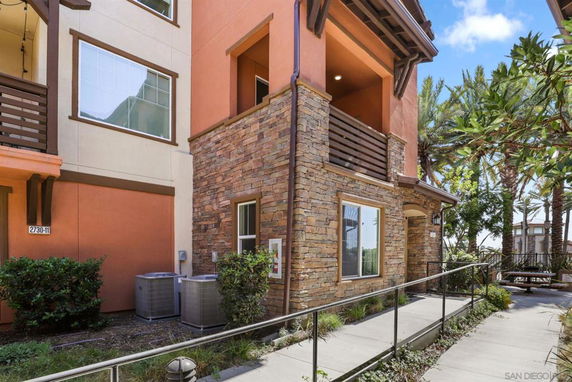 Front view of a multi-story building with stone and orange exterior finish.
