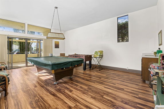Room with a pool table and a foosball table.