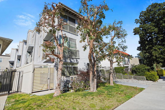 Front view of a multi-story residential building with balconies.