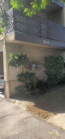 Exterior view of a building with a balcony and address number 9131.