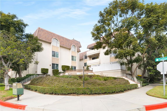 Front view of a multi-story residential building with sloped roofs.