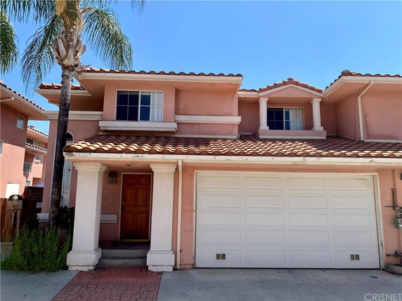 Front view of a two-story house with a double garage.