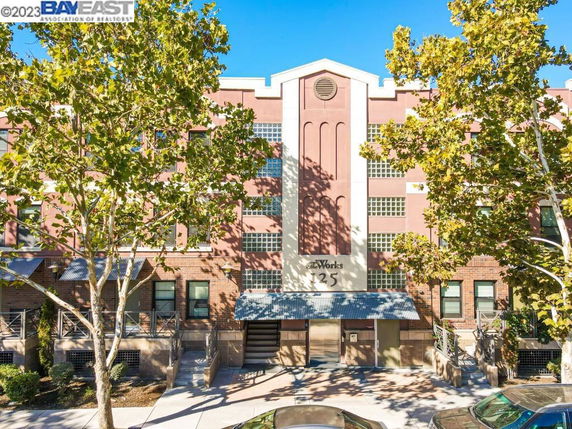 Front view of a multi-story building with brick and glass facade.