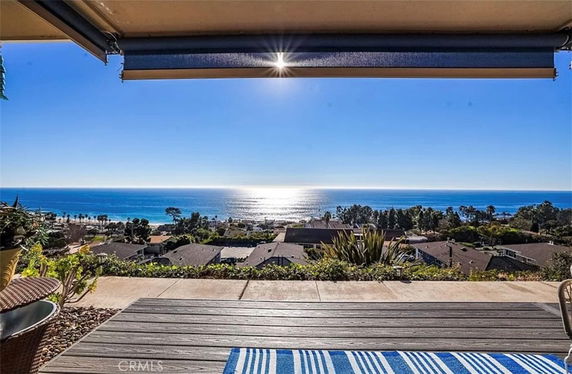 Panoramic view of the ocean and surrounding landscape from a building.